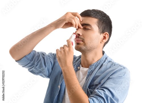 Young man wiping nosebleed ...