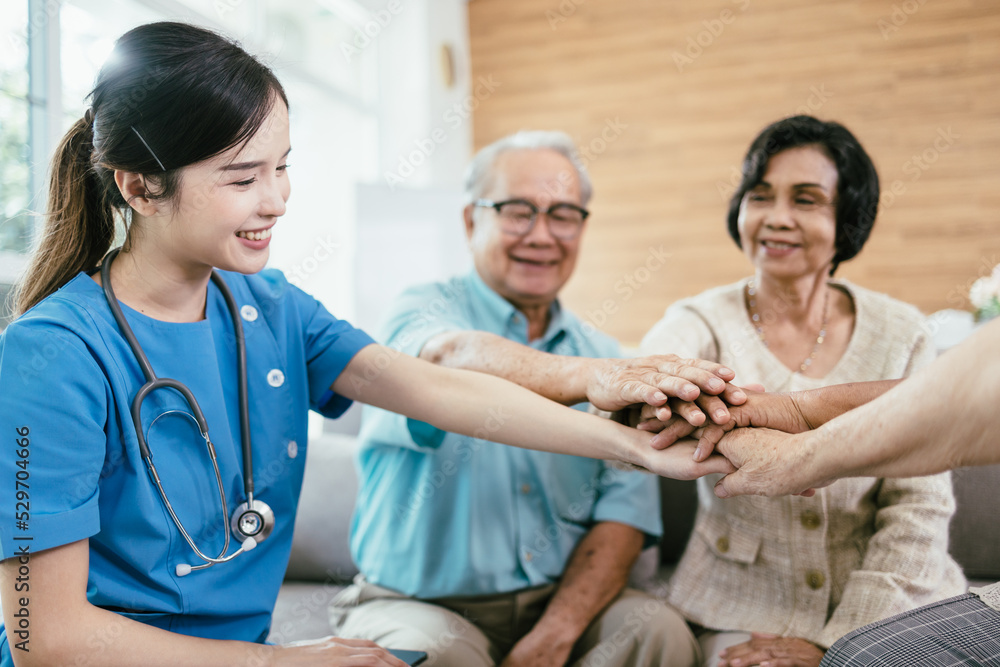 Happy Asian elderly people hands join together in the middle with young woman nursing elderly care. Happy Asian elderly people hands join together in the middle with young woman nursing elderly care.