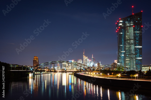 Frankfurt city at night with light reflections in the river.