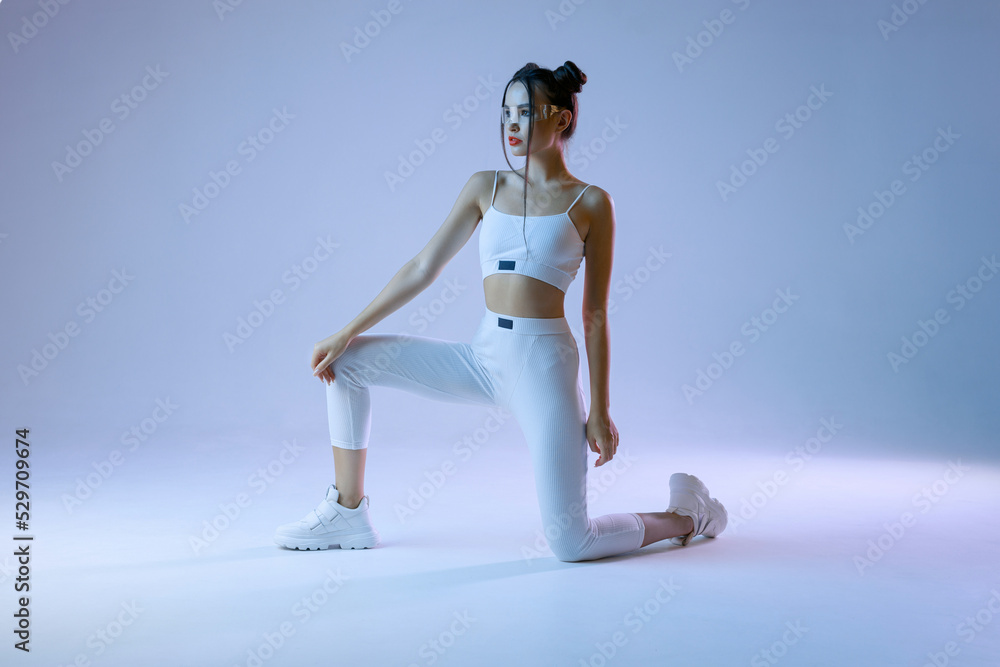 Woman in futuristic sport costume. Augmented reality game, future technology, AI concept. VR. Neon blue light.