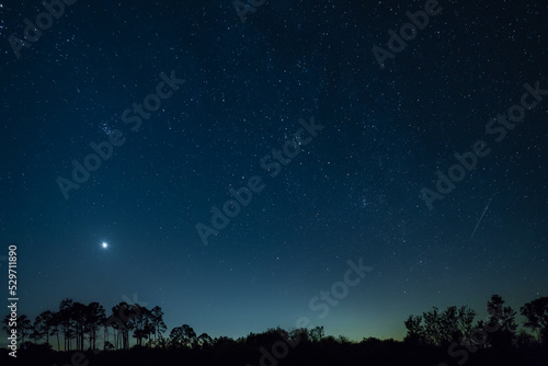 Starry night sky with Venus and a meteor visible
