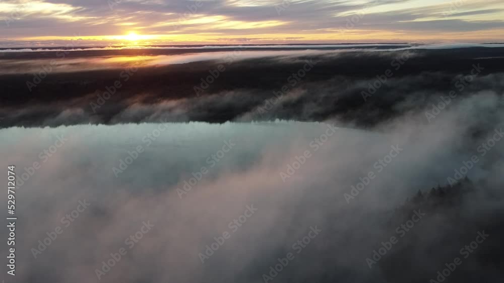 Flying over foggy lake early morning at sunrise. Drone video. Flying over foggy lake early morning at sunrise. Drone video.