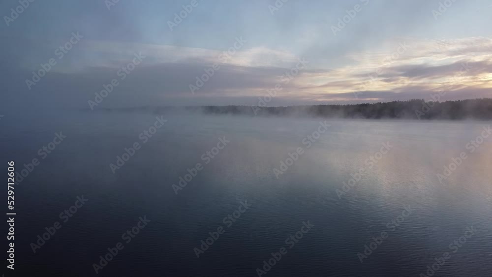 Flying over foggy lake early morning at sunrise. Drone video. Flying over foggy lake early morning at sunrise. Drone video.