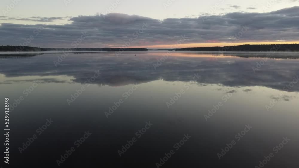 Flying over foggy lake early morning at sunrise. Drone video. Flying over foggy lake early morning at sunrise. Drone video.