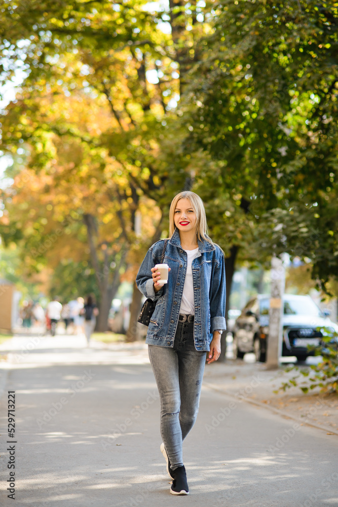 girl walks through the autumn city