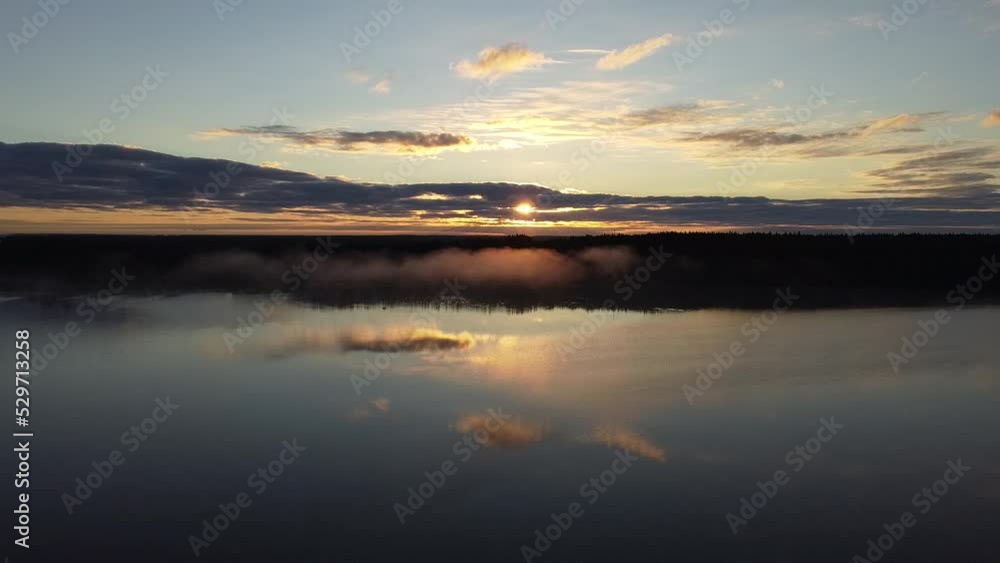 Flying over foggy lake early morning at sunrise. Drone video. Flying over foggy lake early morning at sunrise. Drone video.