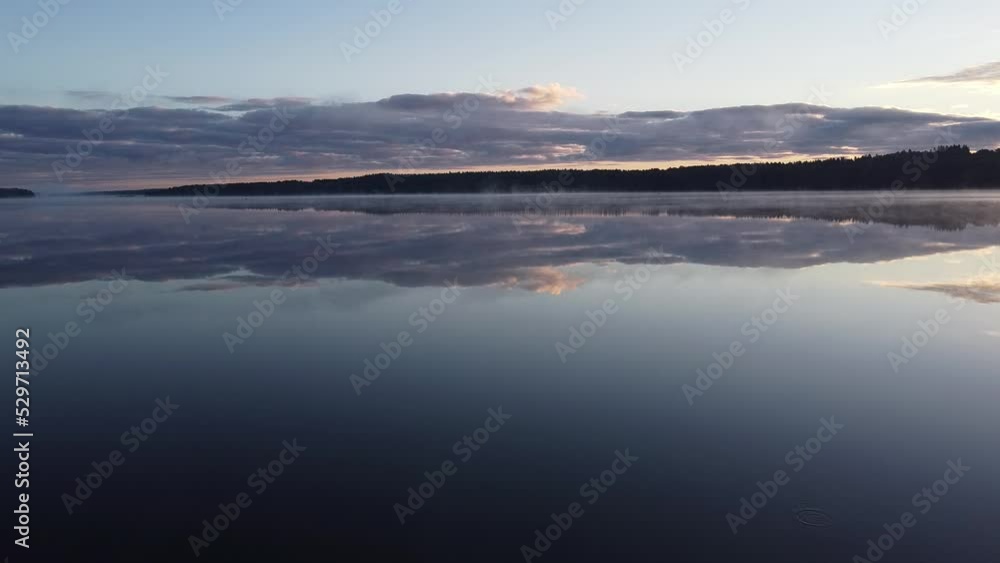 Flying over foggy lake early morning at sunrise. Drone video. Flying over foggy lake early morning at sunrise. Drone video.
