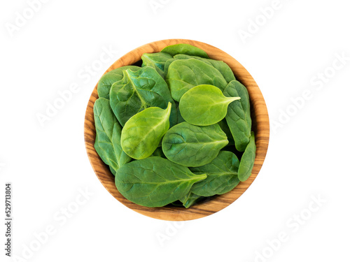 Spinach leaves in the olive wood bowl top view isolated transparent png. Green vegetable flay lay.