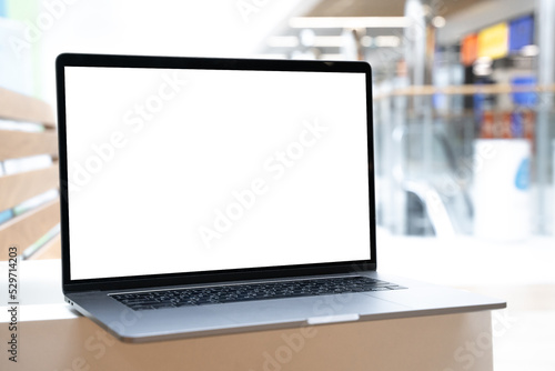 Wallpaper Mural Laptop with white screen in business office or shopping mall. Empty copy space, blank screen mockup. Soft focus laptop with interor background. Travel, study and office work concept Torontodigital.ca