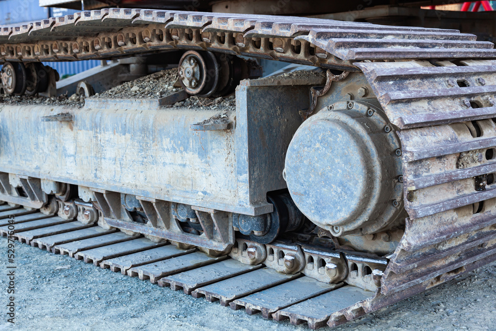 Close-up of metal tracks of a crawler crane with steel wheels. Chassis tracked vehicles.