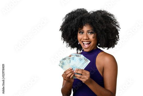 young black woman smiling holding brazilian money bills, positively surprised, space for text, person, advertising concept 
