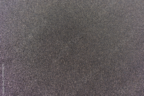 Black and dark gray rubber CBR EPDM granulated coating background on the outdoor sports and kids playground places