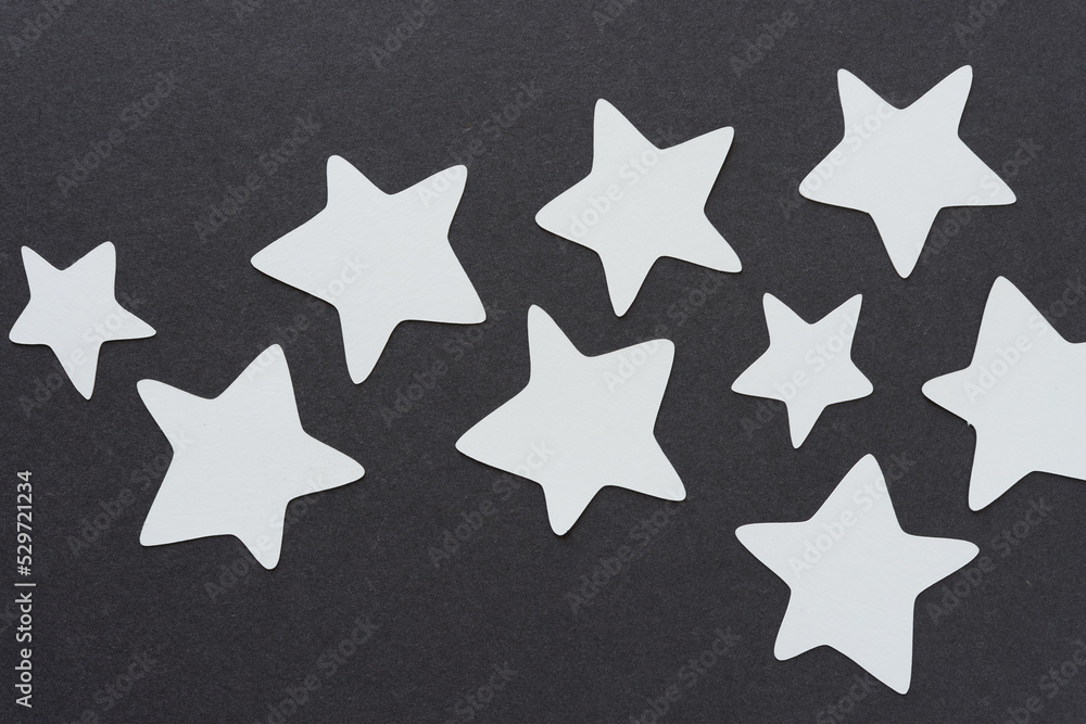 Obraz premium gray paper stars on dark gray paper