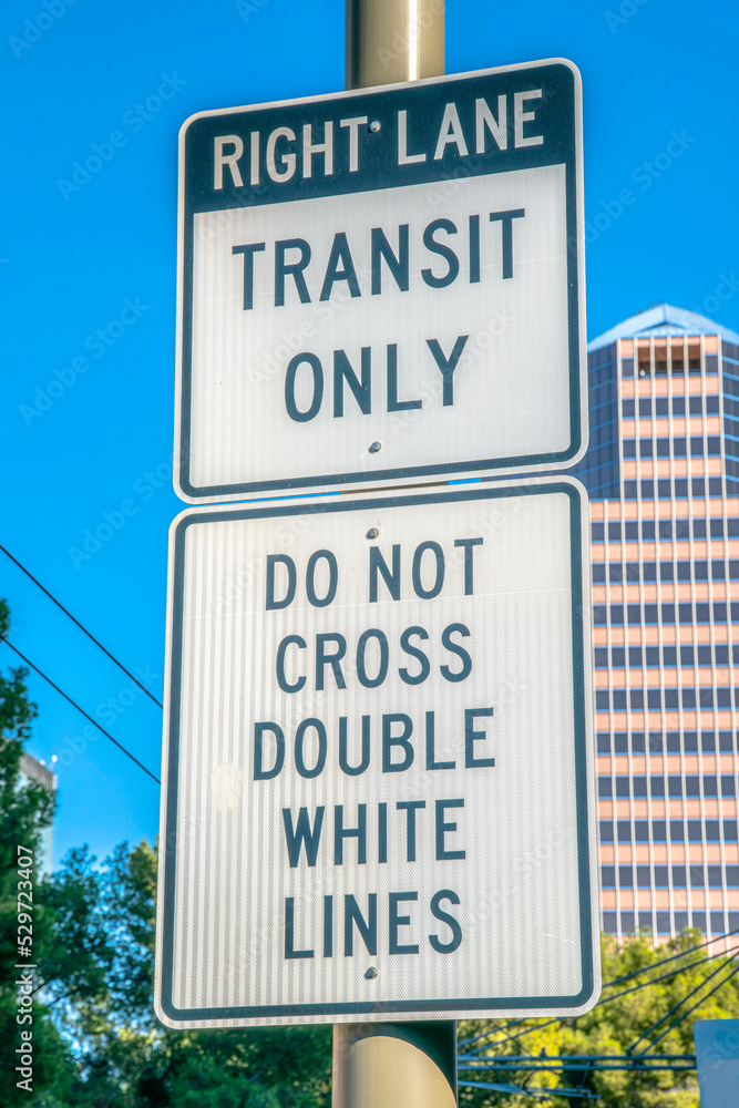 Right lane transit only and do not cross double white lines road signs in downtown Tucson, Arizona Right lane transit only and do not cross double white lines road signs in downtown Tucson, Arizona