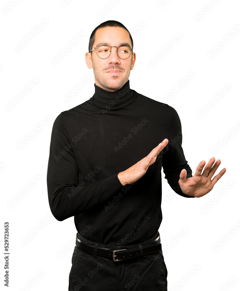 Fototapeta premium Friendly young man doing a gesture of keep calm