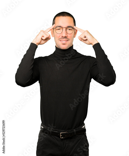 Happy young man doing a gesture of concentration