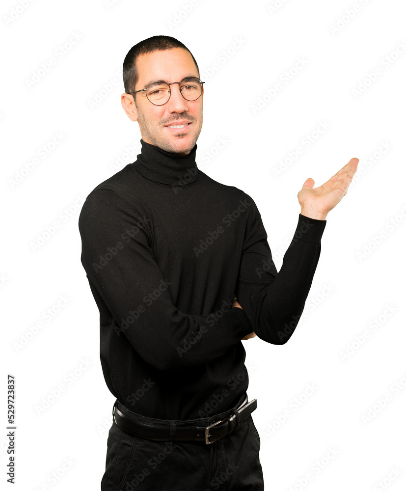 Friendly young man making a gesture of welcome Friendly young man making a gesture of welcome
