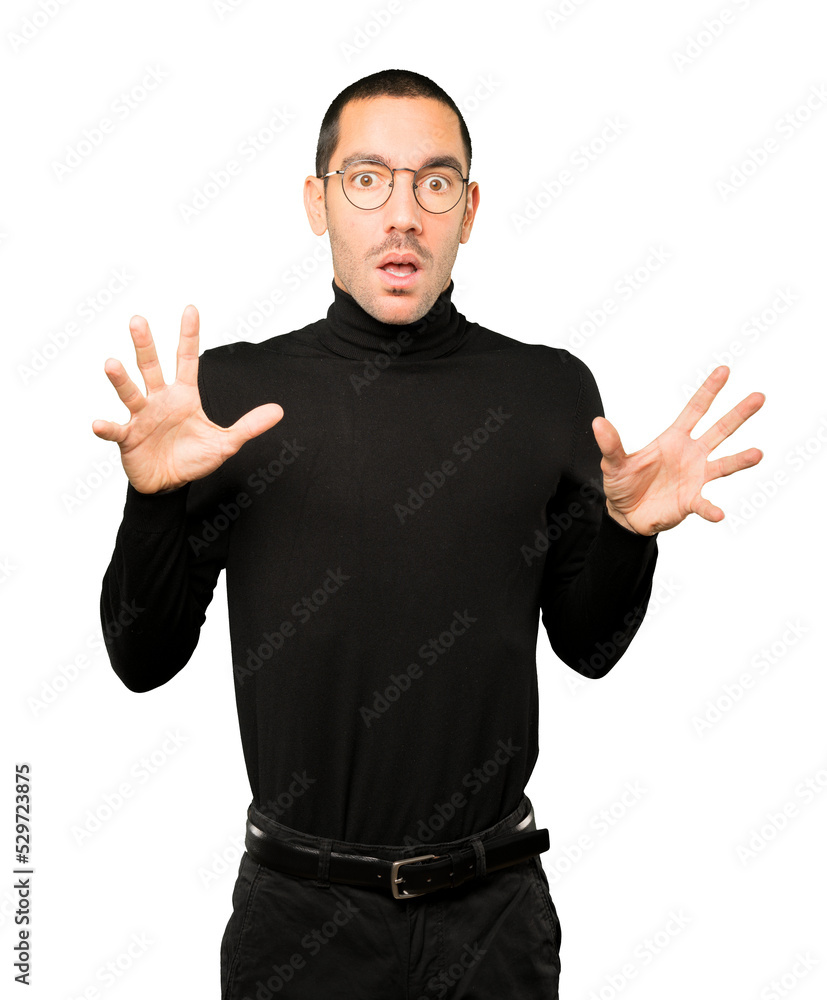 Fototapeta premium Scared young man screaming against background