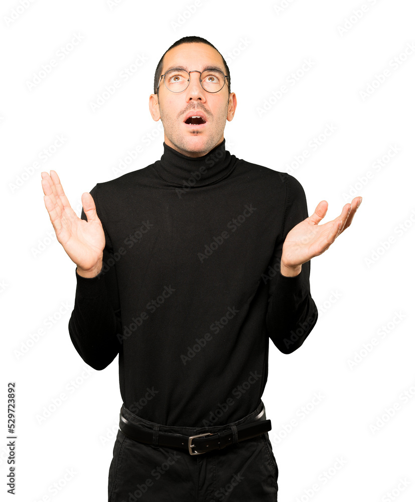 Happy young man looking up gesture Happy young man looking up gesture