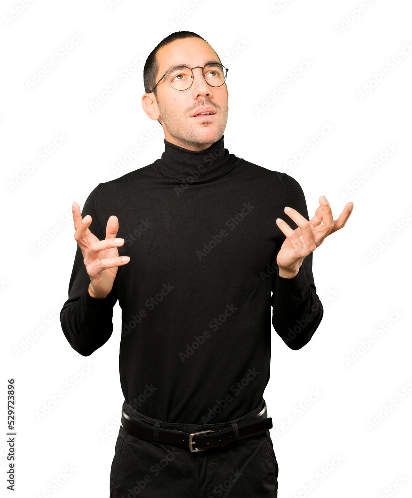 Happy young man looking up gesture Happy young man looking up gesture