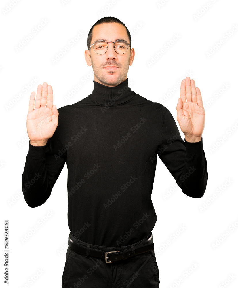 Happy young man making a gesture of stop with his palm Happy young man making a gesture of stop with his palm