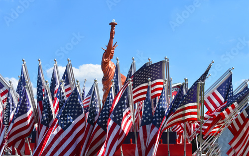 USA American Flags with the Stature of Liberty Statue