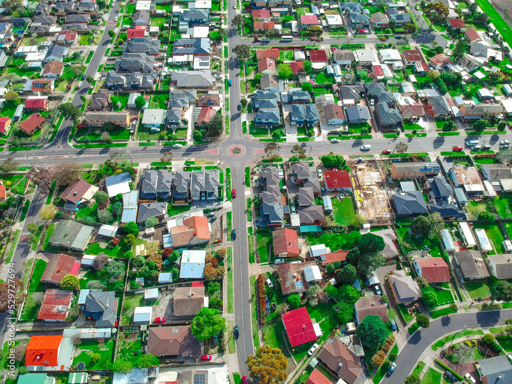 Panoramic aerial Drone view of Melbournes suburbs and CBD looking down at Houses roads and Parks Victoria Australia. Beautiful colours at Sunset