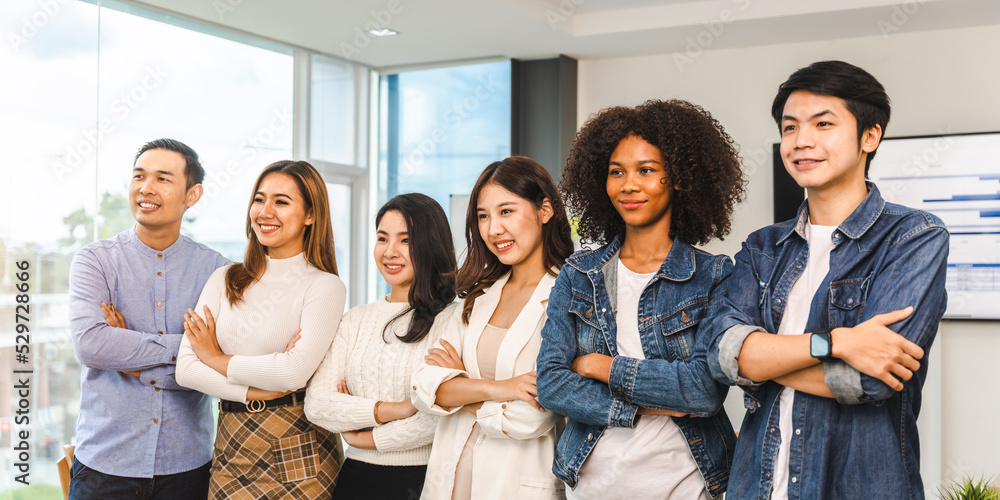Young and successful mixed race diverse colleagues working on project together looking at camera, friendship, cooperation concept. Young and successful mixed race diverse colleagues working on project together looking at camera, friendship, cooperation concept.