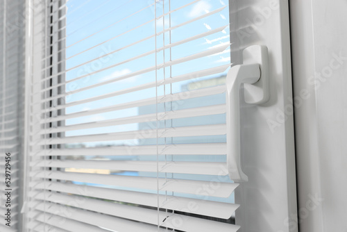 Window with horizontal blinds indoors, closeup view