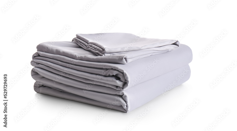 Stack of clean silky bed linen isolated on white Stack of clean silky bed linen isolated on white