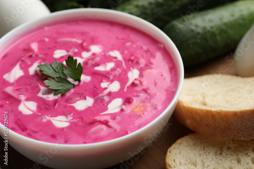 Delicious cold summer beet soup on wooden board, closeup