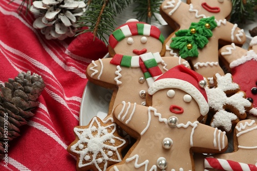 Delicious Christmas cookies, pine cones and fir branches on table, closeup