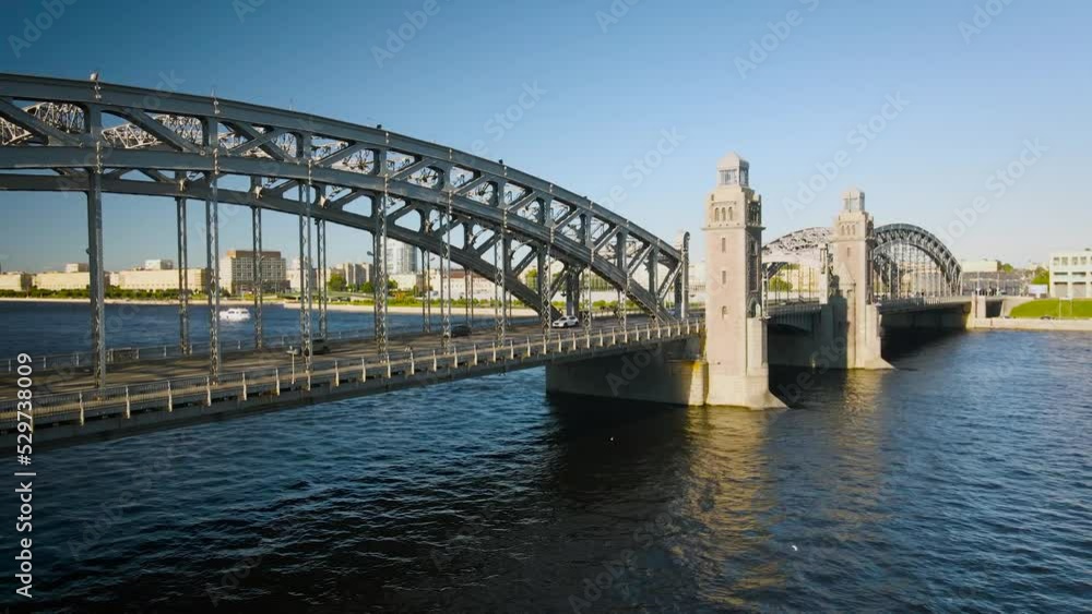 Aerial view of the Bolsheokhtinsky bridge with towers above the river and water channel in the historical and at same time modern centre of city of St. Petersburg at sunny summer sunset Aerial view of the Bolsheokhtinsky bridge with towers above the river and water channel in the historical and at same time modern centre of city of St. Petersburg at sunny summer sunset