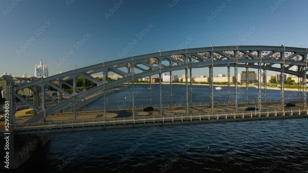 Aerial view of the car Bolsheokhtinsky bridge above the river and water channel in the historical and at same time modern centre of city of St. Petersburg at summer sunset Aerial view of the car Bolsheokhtinsky bridge above the river and water channel in the historical and at same time modern centre of city of St. Petersburg at summer sunset