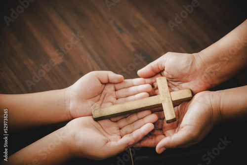 Obraz na plátne Cross in hand prayer to god on dark in church concept for faith spirituality and religion woman person praying on holy bible in morning