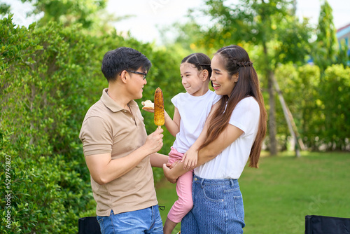 Family happy picnic time , Parent and child enjoy to eating outdoor meal on green yard © bank215