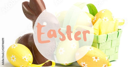 Close-up of easter text symbol over eggs with chocolate bunny