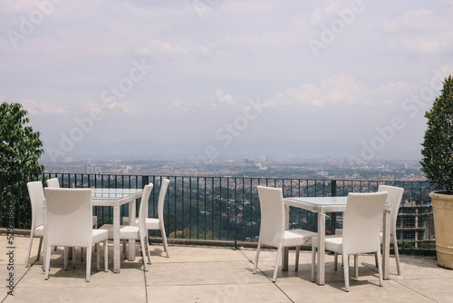 Rooftop cafe, open terrace with rattan tables and chairs