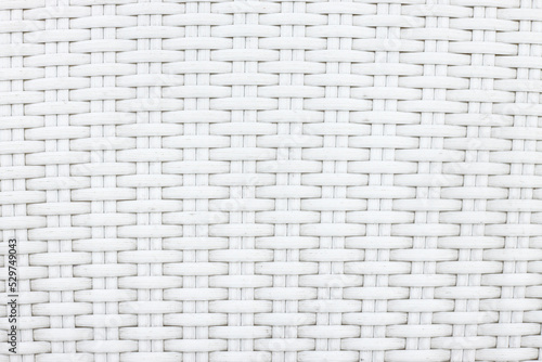 White artificial rattan pattern. Background of basket structure close-up. Furniture backdrop.