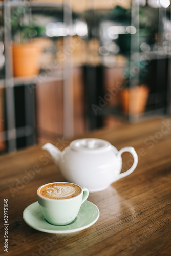 Hot coffee latte on wooden table in cafe