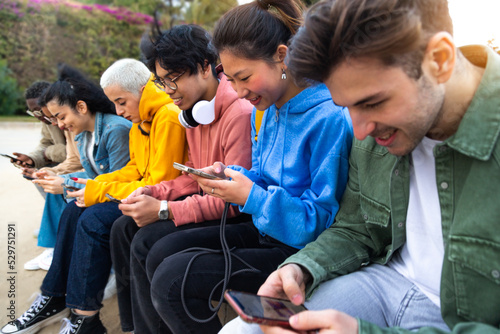 Fotografi Group of diverse teenage college students ignoring each other using smartphone checking social media