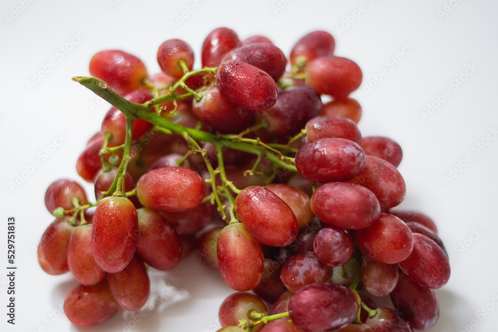 1 bunch of red ripe grapes on a white background 1 bunch of red ripe grapes on a white background