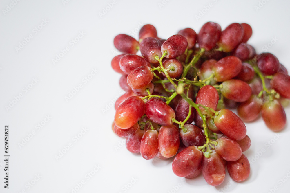 1 bunch of red ripe grapes on a white background