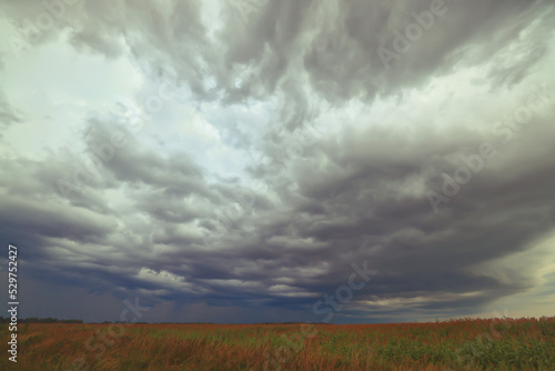 cloudscape field hay rolls sky clouds autumn, gloomy weather agriculture