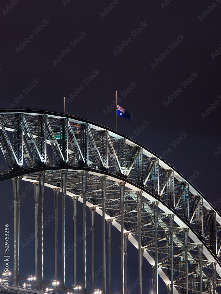 Sydney Harbour Bridge with Australia flag in half-mast.