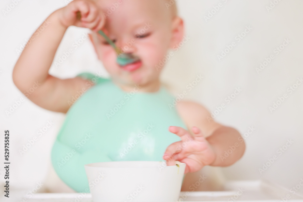 kid eats with a spoon and learns by himself kid eats with a spoon and learns by himself