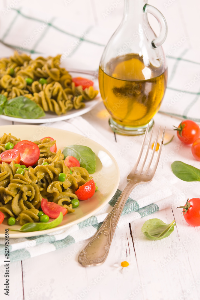 Fusilli pasta with cherry tomatoes and peas. Fusilli pasta with cherry tomatoes and peas.