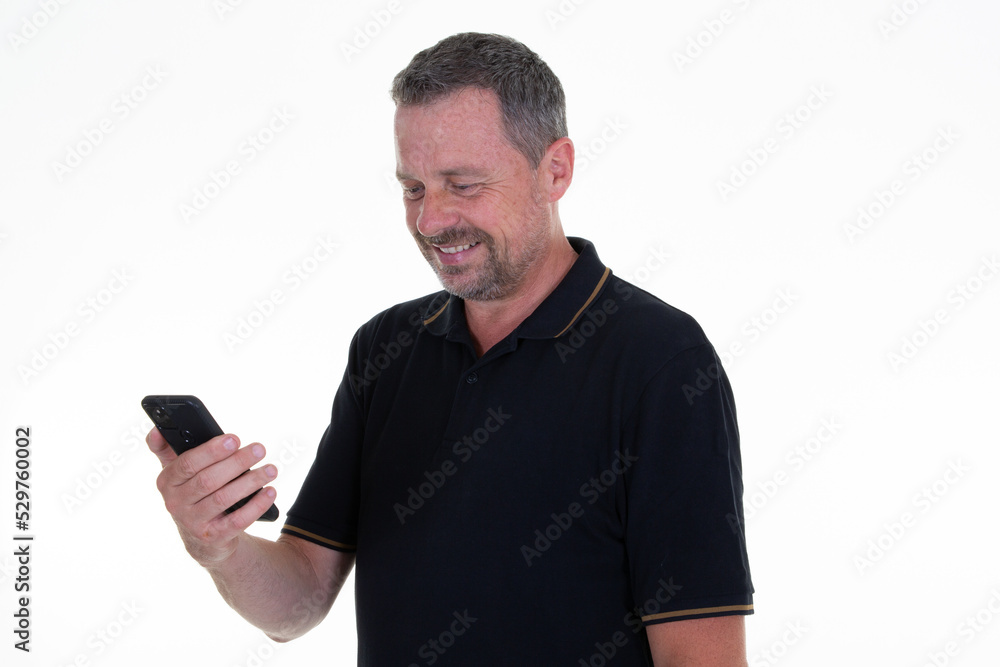 Middle aged man using texting mobile phone and text cell smartphone messaging on white isolated background Middle aged man using texting mobile phone and text cell smartphone messaging on white isolated background