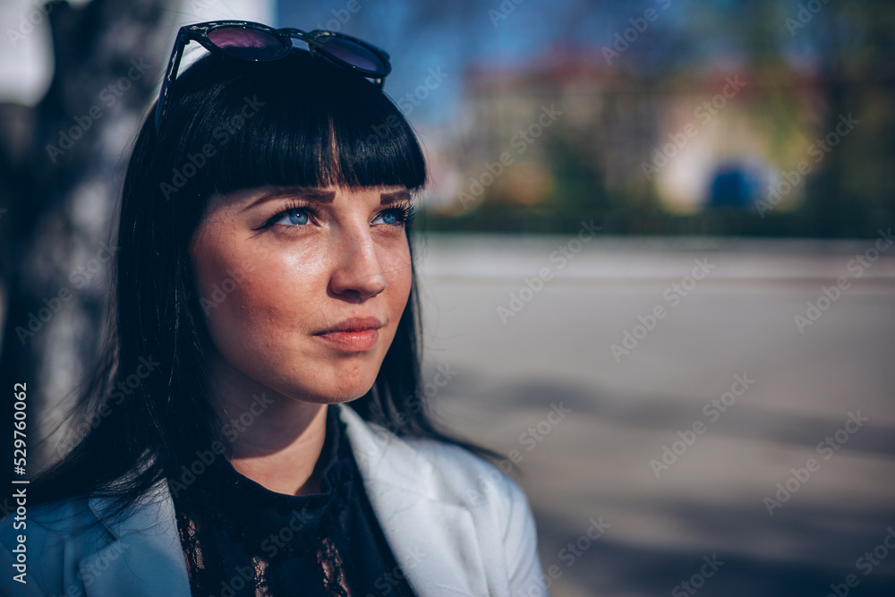 portrait of a stylish brunette in sunglasses on a sunny day portrait of a stylish brunette in sunglasses on a sunny day