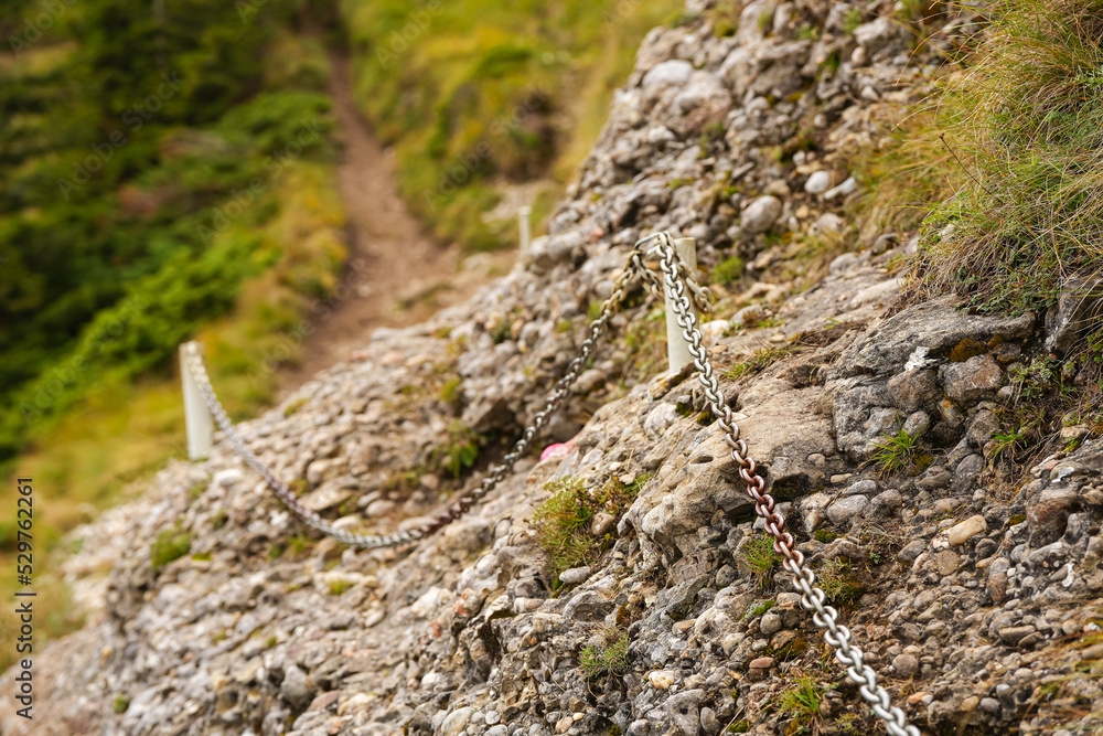 Some chains placed on a rock in a mountain hiking trail used as safety measure for the mountaineers people who hike. Some chains placed on a rock in a mountain hiking trail used as safety measure for the mountaineers people who hike.